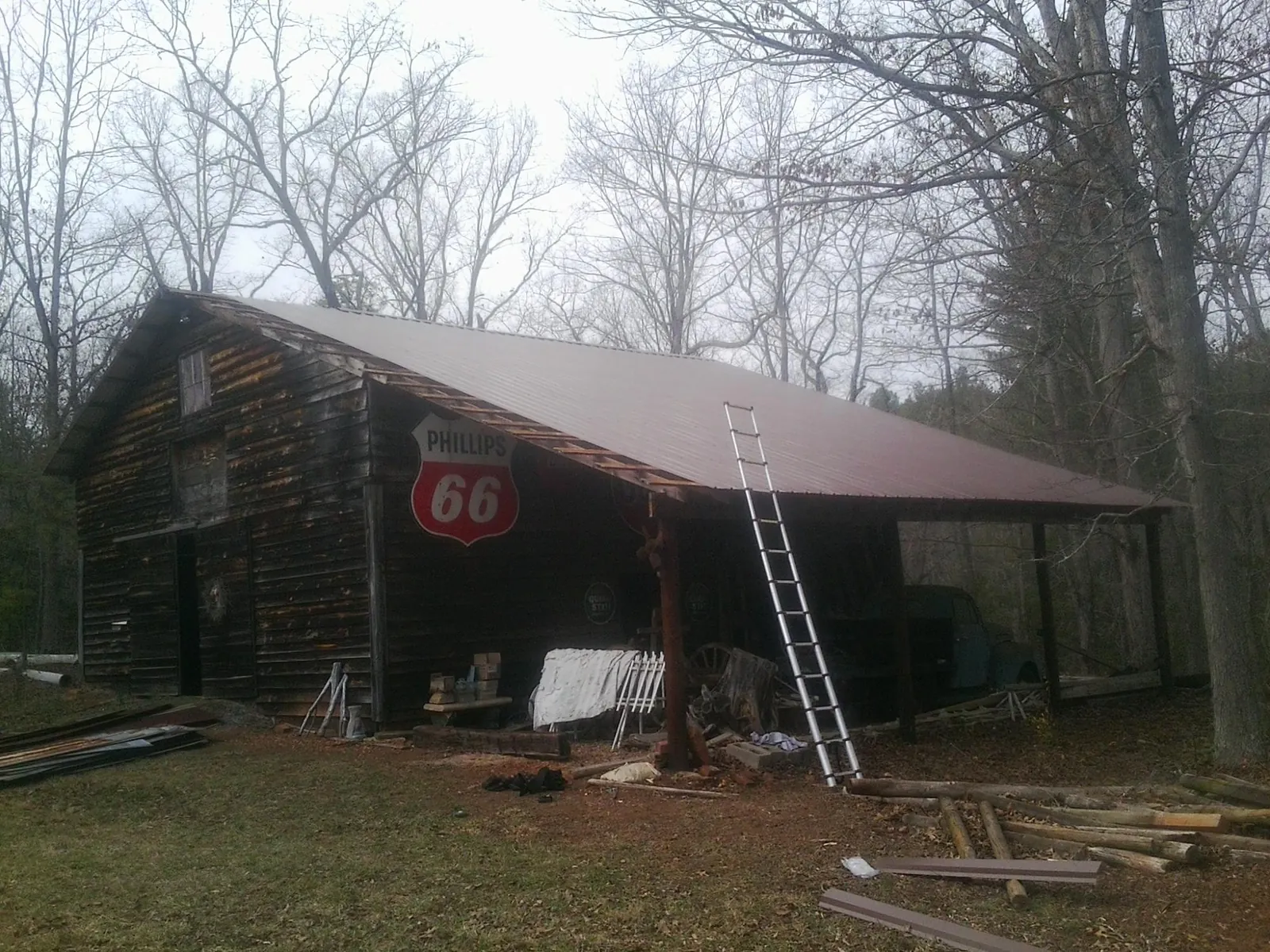 New metal roof on an open sided timber barn with a vintage sign in Taylor
